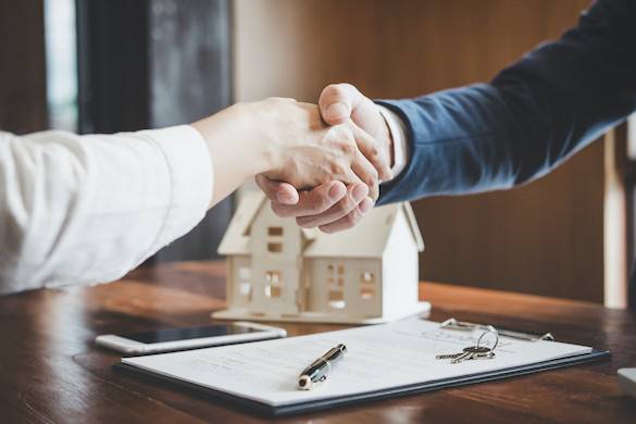 Real estate agent and customer handshake small