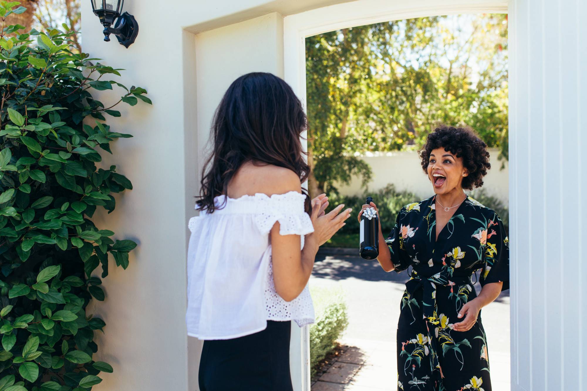 Excited woman with wine bottle