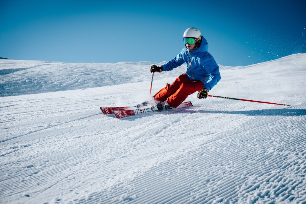 Downhill skier in a blue jacket