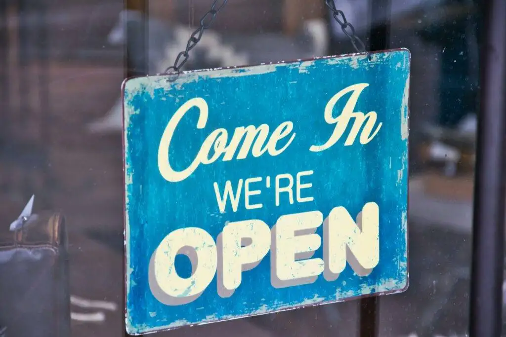 Blue open sign on a door of new Leesburg restaurants in 2025 and Loudoun County from top local real estate agents Garrell Group