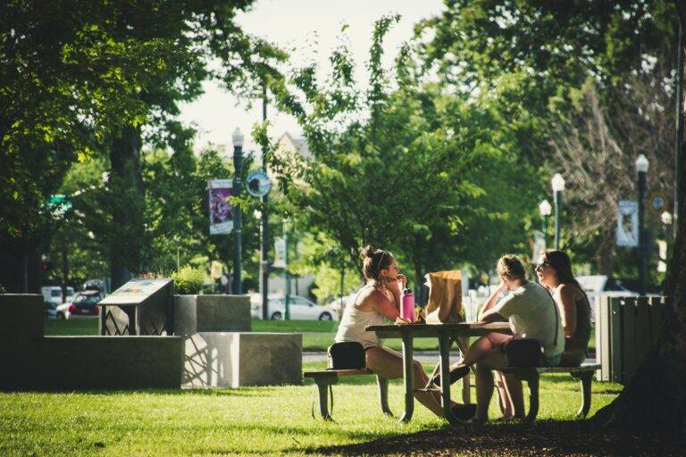 Women sit on park benches for recreation in Lansdowne on the Potomac where homebuyers love real estate with Jean Garrell Group top agents