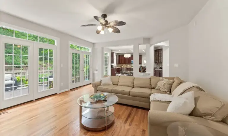 Living room overlooking outdoor space and trees in a Loudoun County luxury property for sale with top local realtor agents Jean Garrell Group