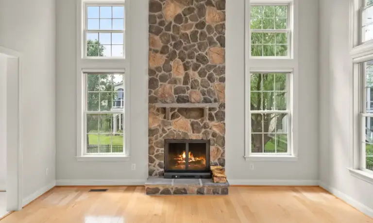 Floor to ceiling stone fireplace in a luxury real estate listing in Lansdowne sold by top Leesburg real estate agents Garrell Group