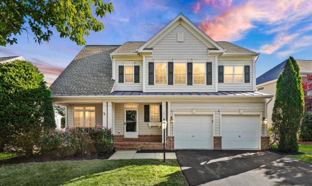 Picturesque Leesburg real estate listing, a white traditional home with green lawn and brick porch, sold by top local realtor agents the Jean Garrell Group