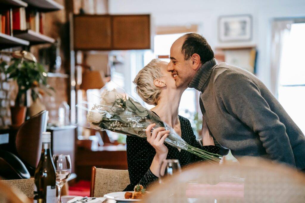A woman kisses the cheek of a man who gave her flowers on Valentine’s in Loudoun County