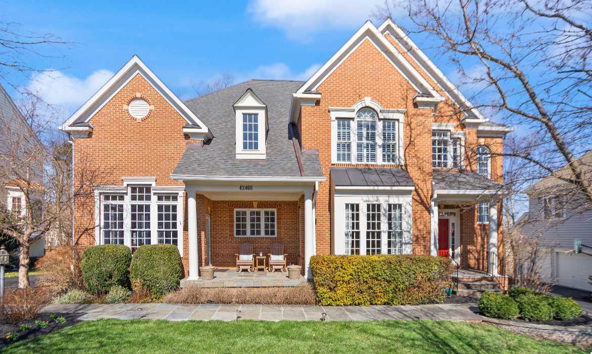Luxury home with brick facade and porch in Lansdowne on the Potomac, listed by the best realtors for selling a home in Loudoun County