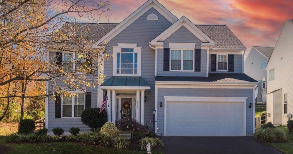Front exterior of a Sterling real estate listing at dusk, sold by the best realtor agents for buying a home in Loudoun County