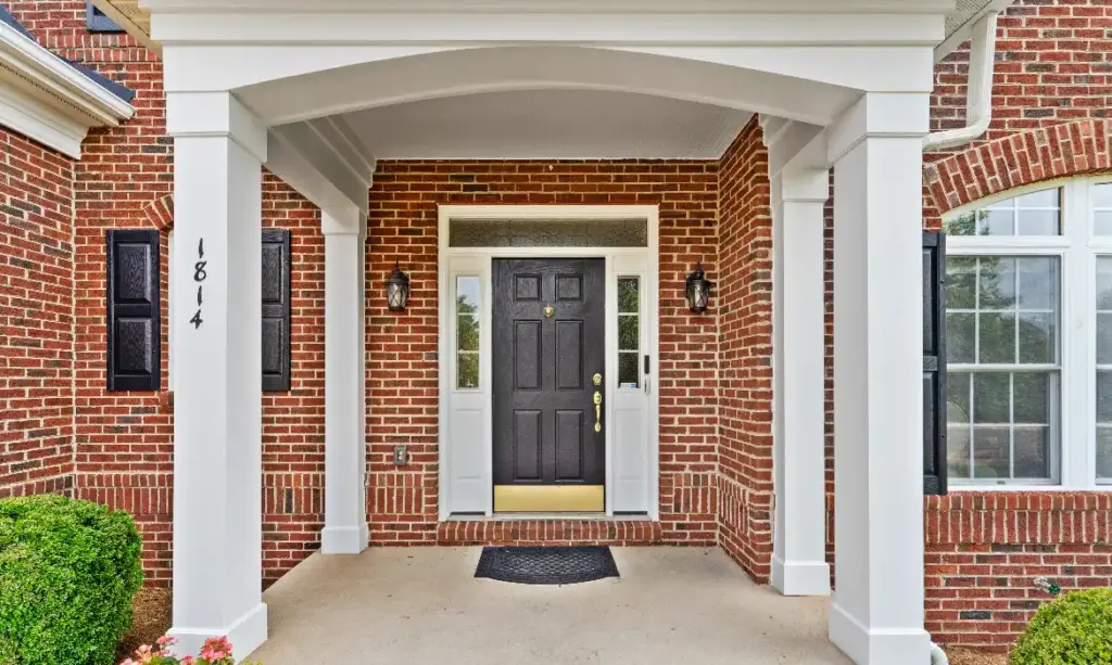 Front porch and entryway of a brick Colonial home in Lansdowne on the Potomac, sold by top listing agent Jean Garrell