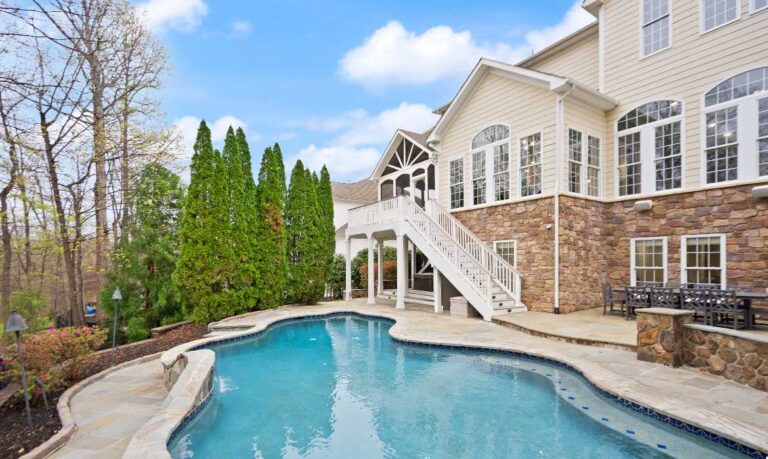 Backyard of a luxury home in Lansdowne on the Potomac with a pool and deck