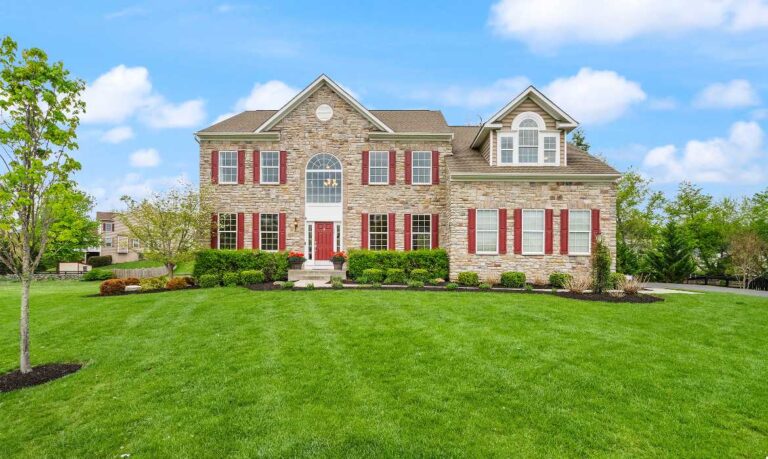 Front exterior of a stately stone-facade home in Loudoun County real estate, showcasing curb appeal and other high ROI prep for sellers with the best local Realtor agent team, Jean Garrell Group
