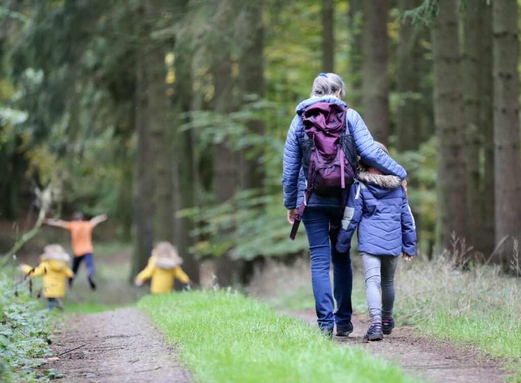 Family walking along a wooded trail, representing outdoor family activities near Potomac Falls, Virginia.